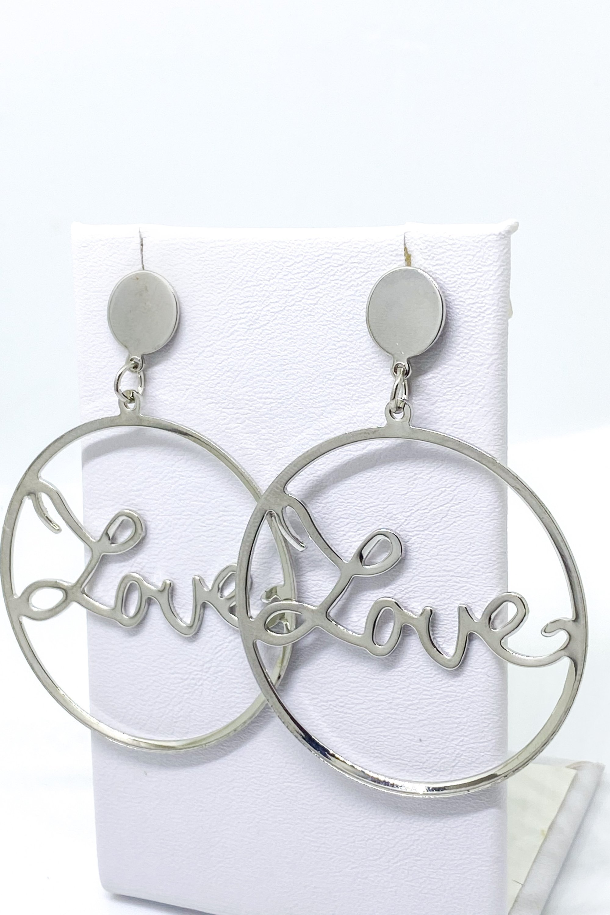 A pair of elegant dangle hoop earrings in silver and gold, showcasing a geometric round design made from high-quality zinc alloy.