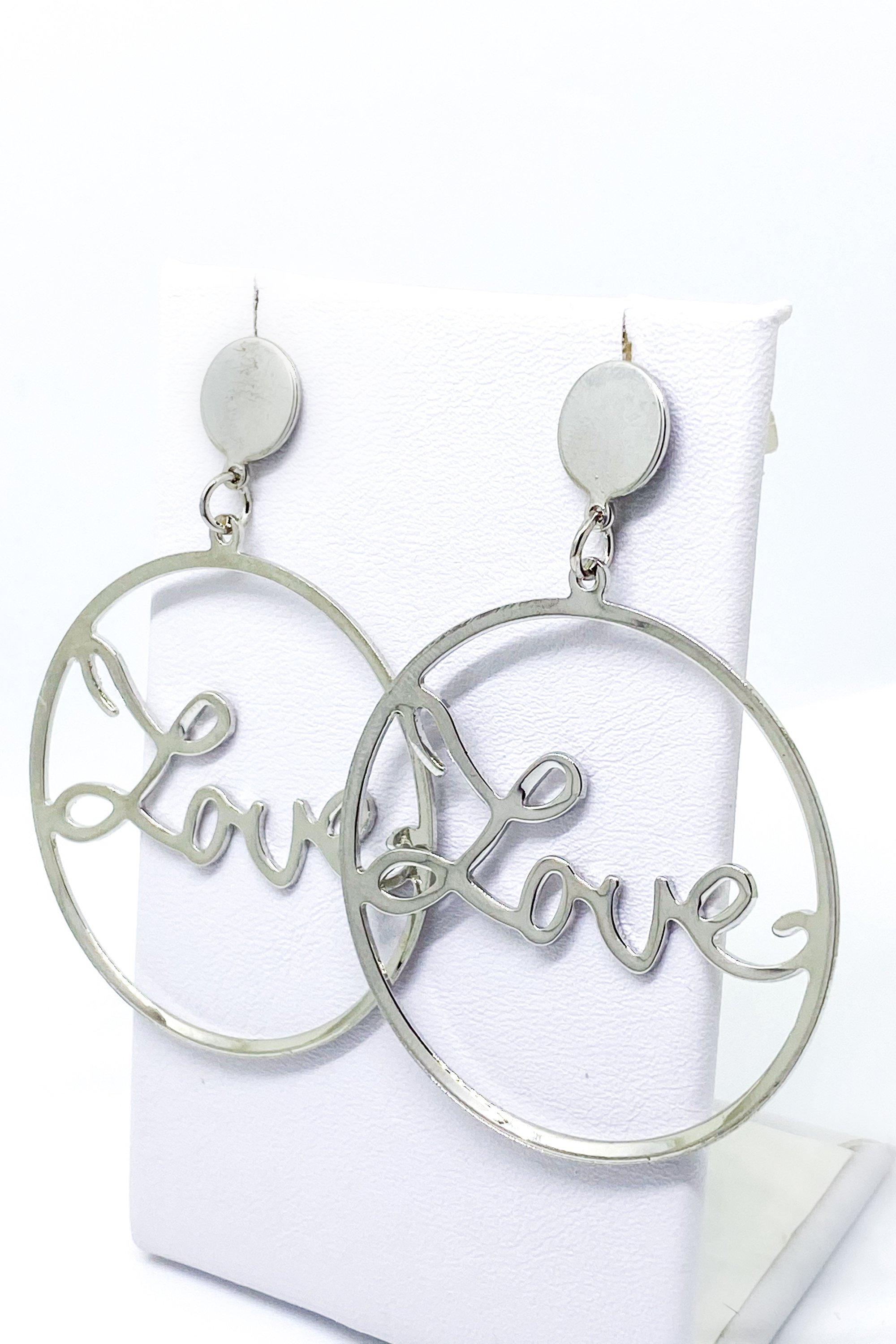 A pair of elegant dangle hoop earrings in silver and gold, showcasing a geometric round design made from high-quality zinc alloy.