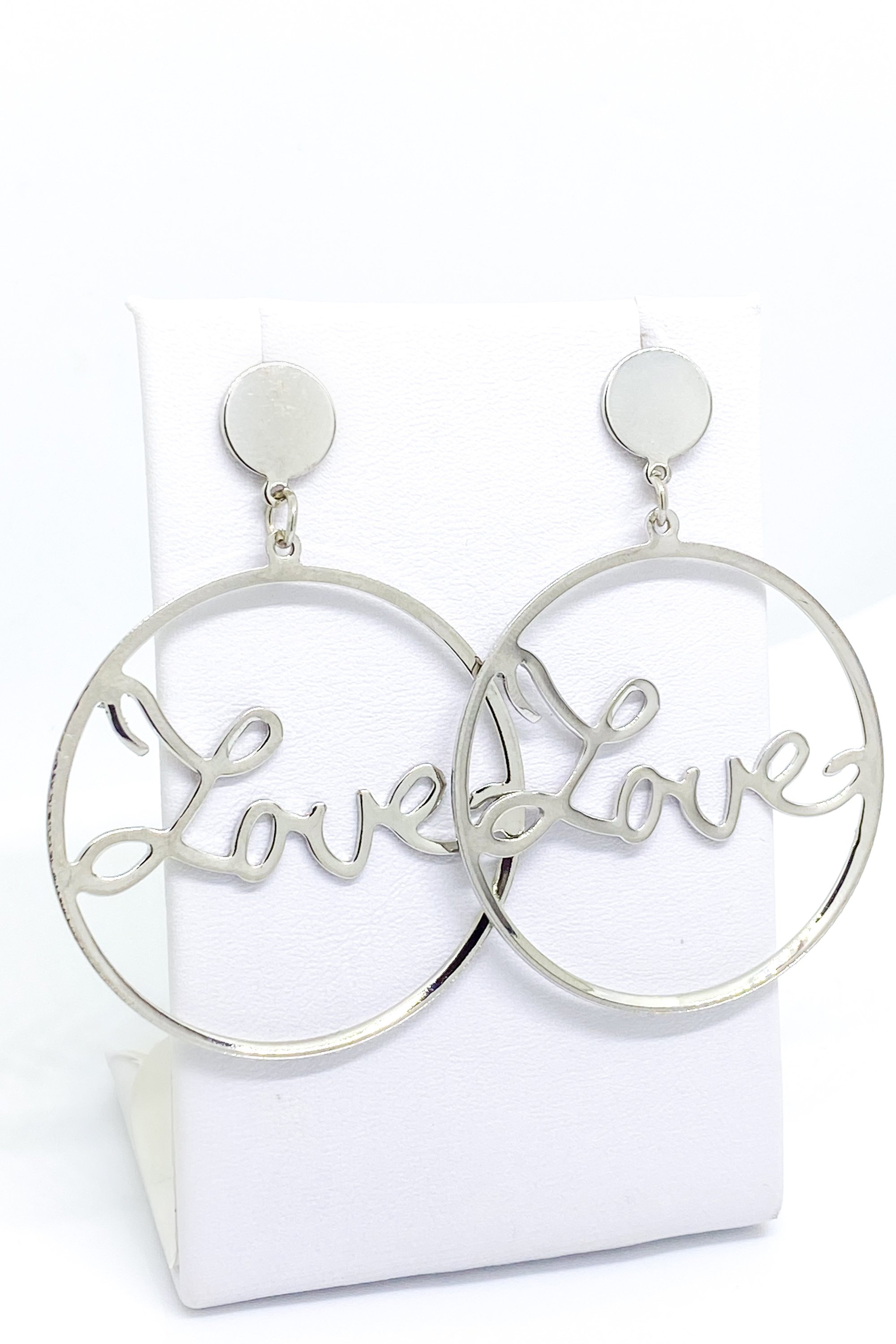 A pair of elegant dangle hoop earrings in silver and gold, showcasing a geometric round design made from high-quality zinc alloy.