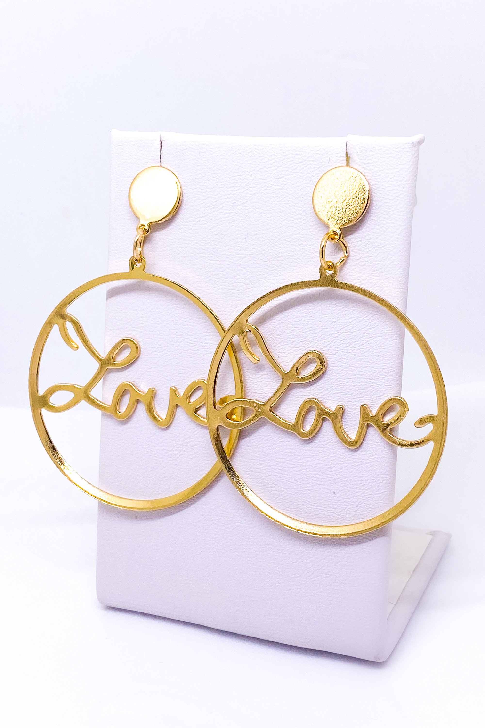 A pair of elegant dangle hoop earrings in silver and gold, showcasing a geometric round design made from high-quality zinc alloy.