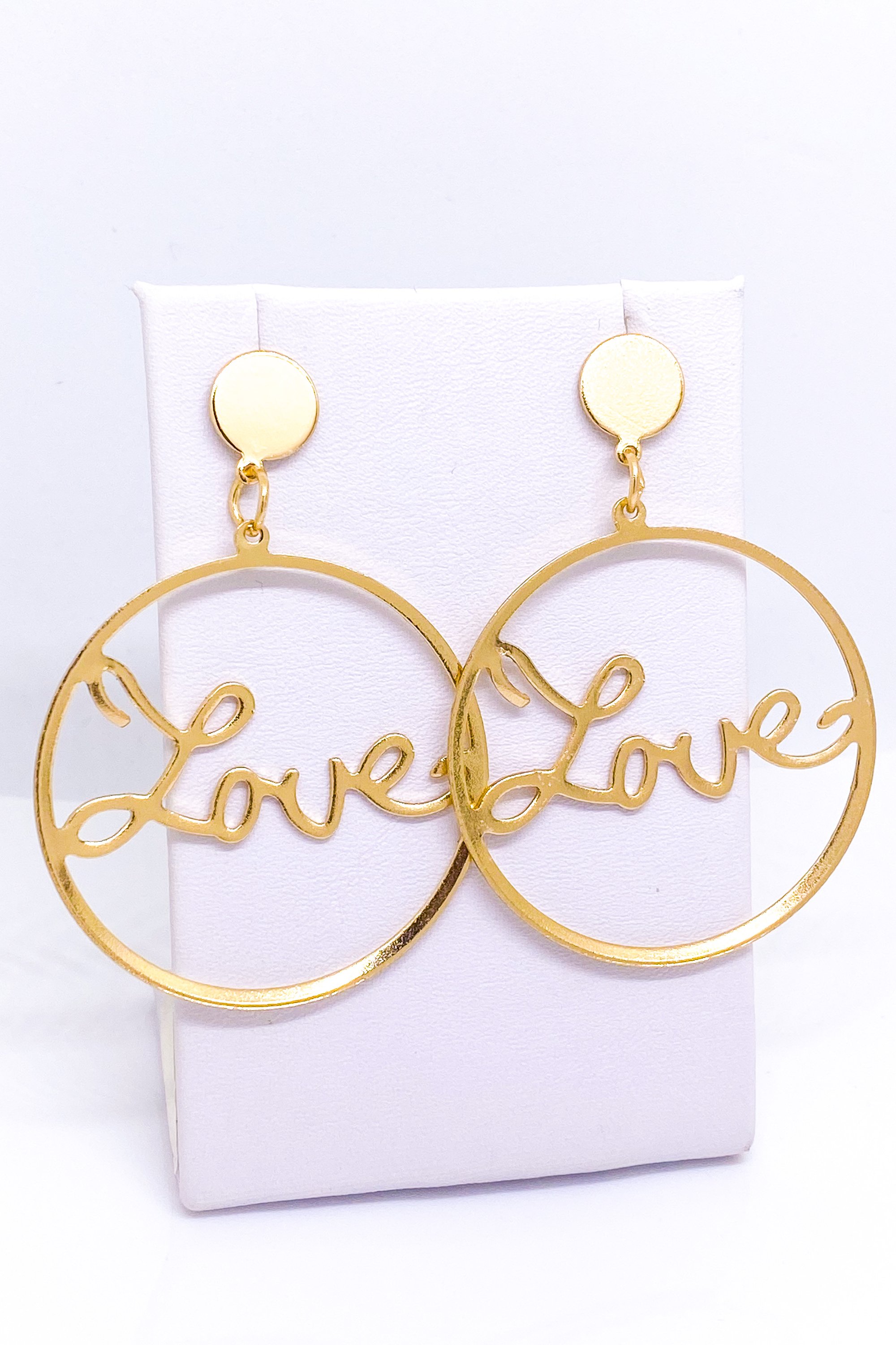 A pair of elegant dangle hoop earrings in silver and gold, showcasing a geometric round design made from high-quality zinc alloy.