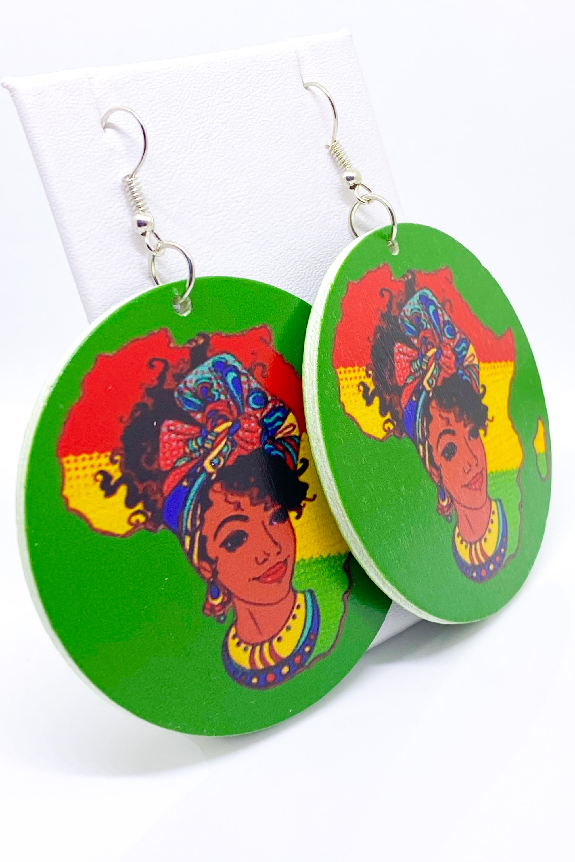 Colorful handmade wooden hoop earrings in green, red, and yellow, showcasing a vibrant cultural design.