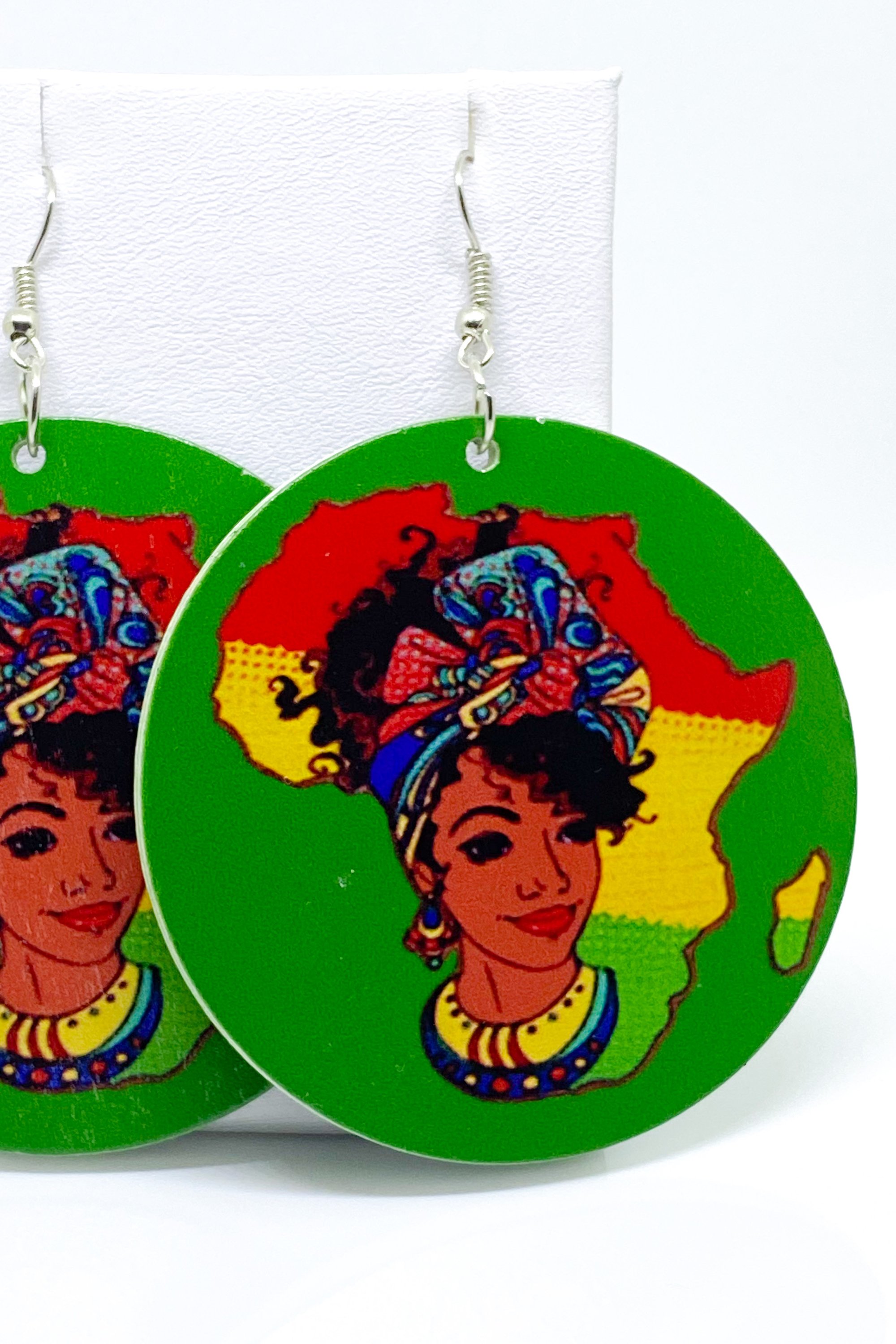 Colorful handmade wooden hoop earrings in green, red, and yellow, showcasing a vibrant cultural design.