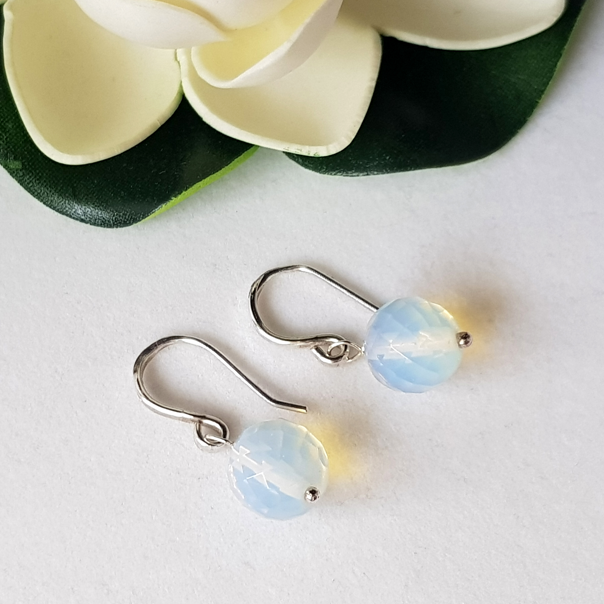 A pair of elegant Jelly Opal Dangle Earrings featuring 11mm faceted opals in solid sterling silver, showcasing vibrant colors.