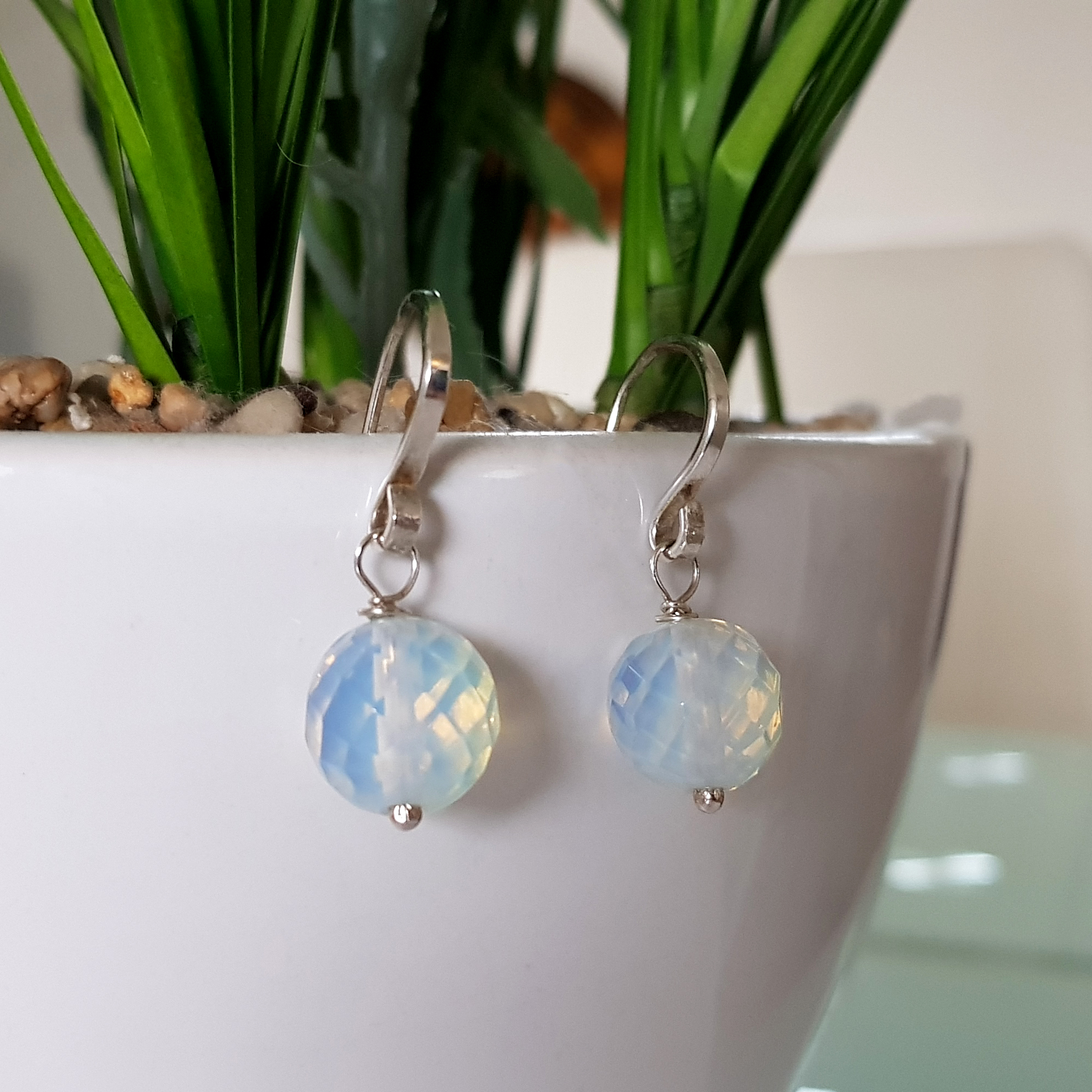 A pair of elegant Jelly Opal Dangle Earrings featuring 11mm faceted opals in solid sterling silver, showcasing vibrant colors.