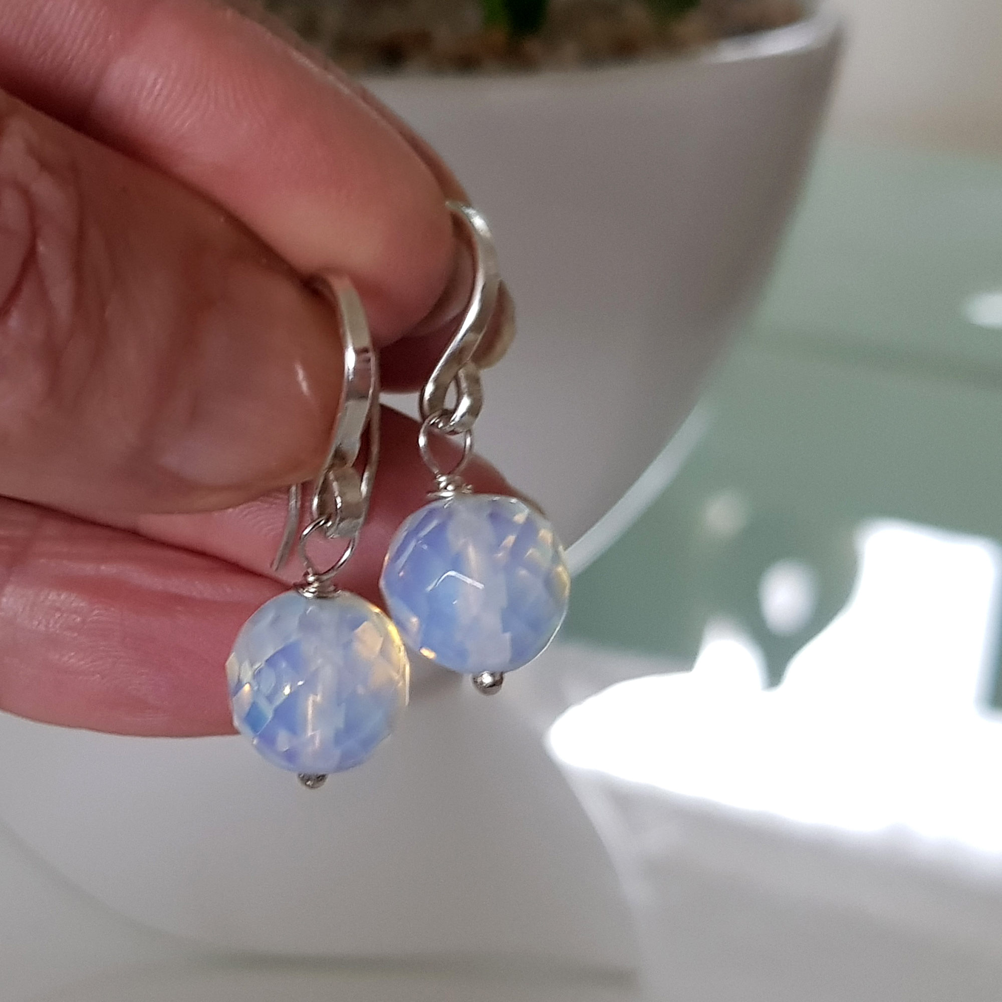 A pair of elegant Jelly Opal Dangle Earrings featuring 11mm faceted opals in solid sterling silver, showcasing vibrant colors.