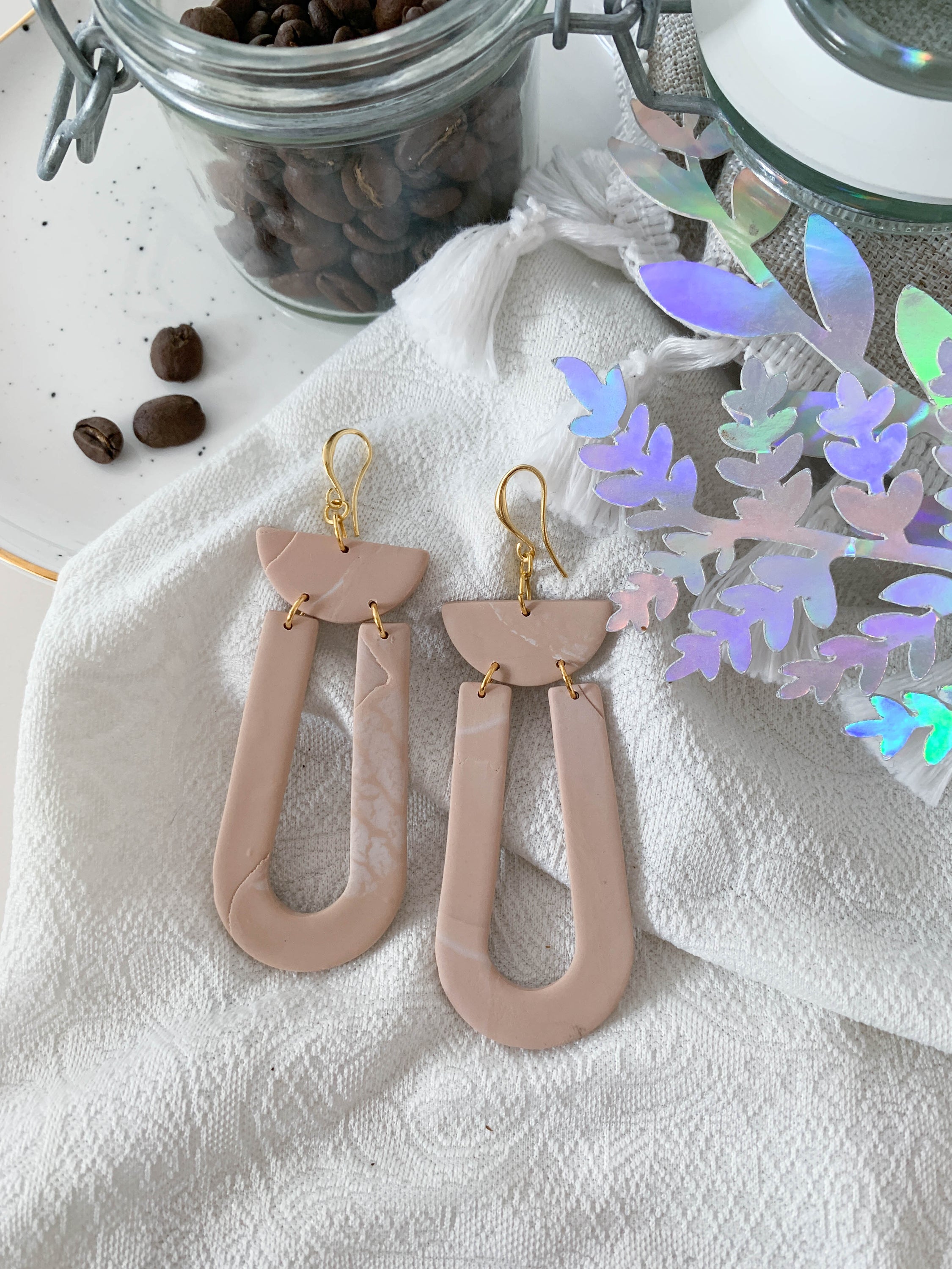 Handmade Josie Latte earrings featuring unique marbling and 24k gold plated brass hooks, elegantly designed for stylish wear.