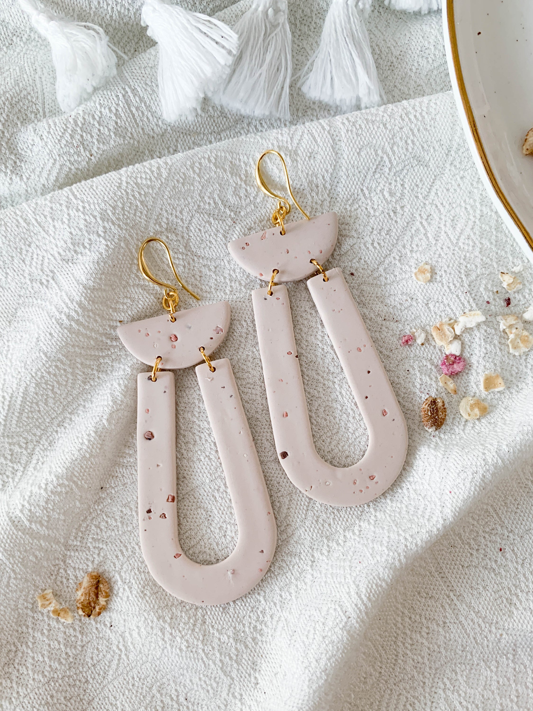 Elegant Josie Oat Milk earrings featuring a scoop dangle design with unique speckles and 24k gold plated brass hooks.