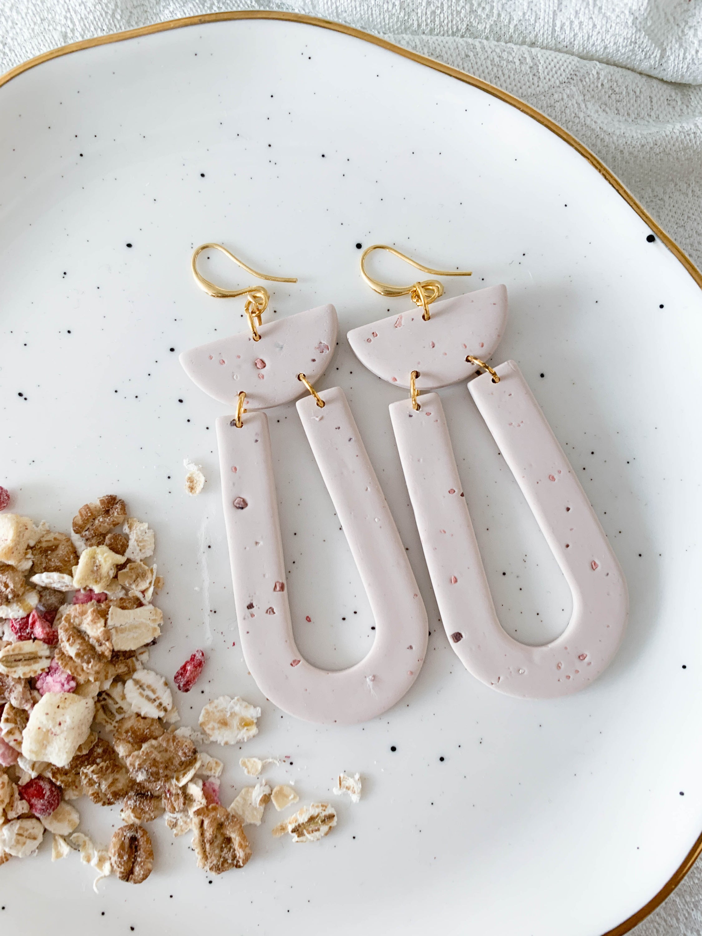 Elegant Josie Oat Milk earrings featuring a scoop dangle design with unique speckles and 24k gold plated brass hooks.