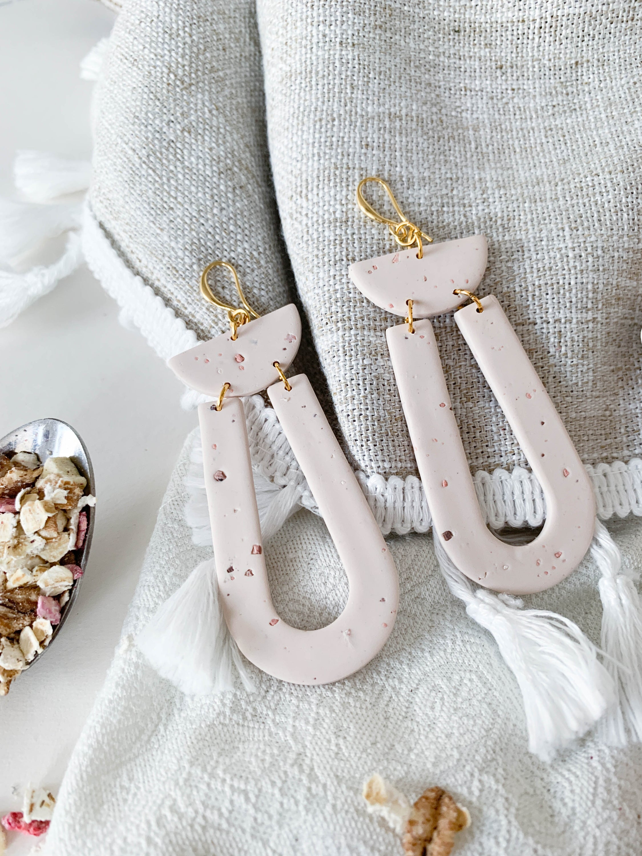 Elegant Josie Oat Milk earrings featuring a scoop dangle design with unique speckles and 24k gold plated brass hooks.