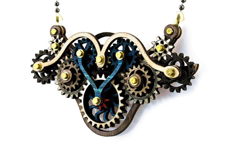 Kinetic Winged Gear Necklace 6004A featuring intricate laser-cut design with moving parts in black, grey, and natural wood.