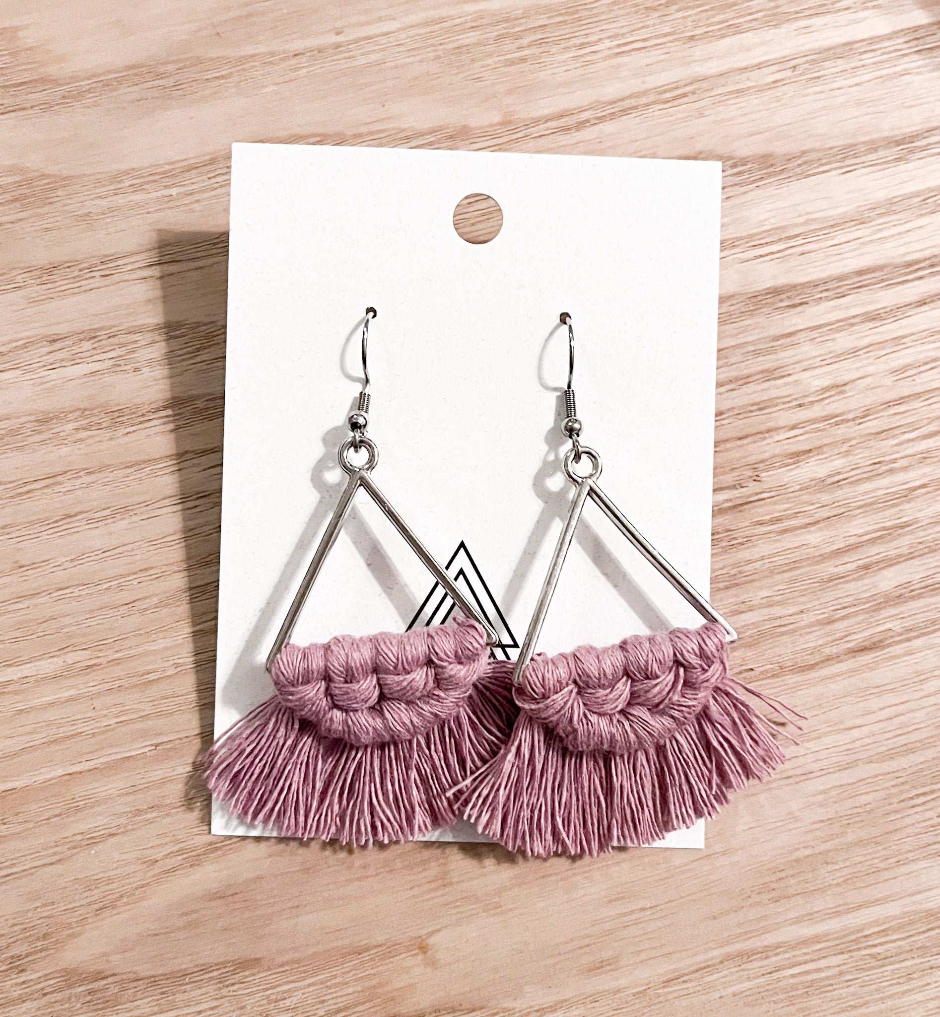 A pair of lavender triangle earrings made from macrame cotton, showcasing a unique and stylish design.