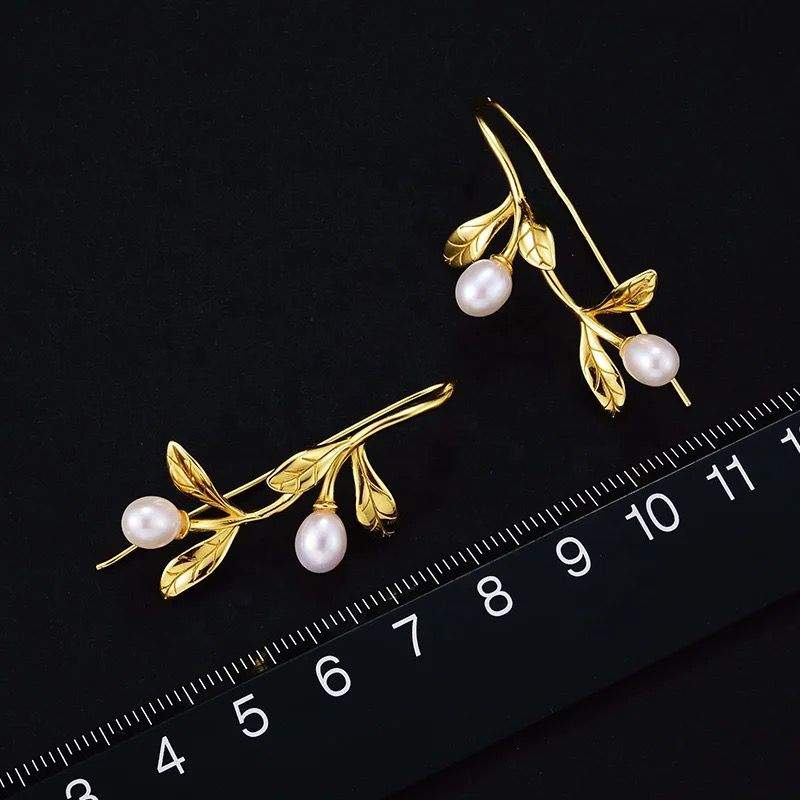 Elegant Leaf and Pearl Earrings featuring a delicate leaf design and lustrous pearls, perfect for any occasion.