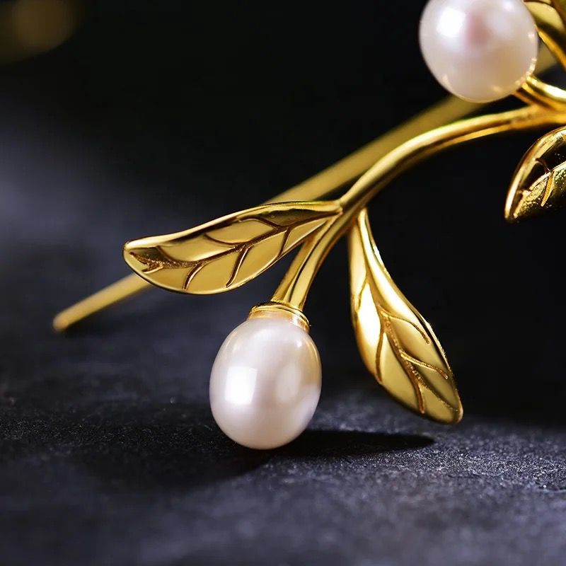 Elegant Leaf and Pearl Earrings featuring a delicate leaf design and lustrous pearls, perfect for any occasion.