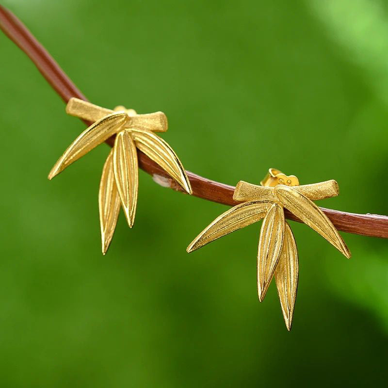 A pair of elegant gold-plated leaf earrings showcasing intricate detailing and a luxurious finish, perfect for any occasion.