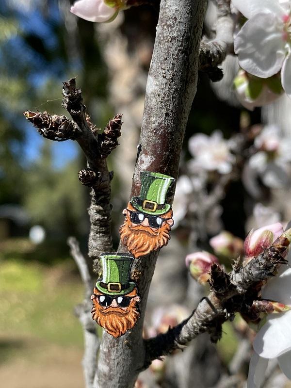 A pair of Leprechaun Stud Earrings made from sustainably sourced wood, featuring a whimsical leprechaun design, lightweight and hypoallergenic.