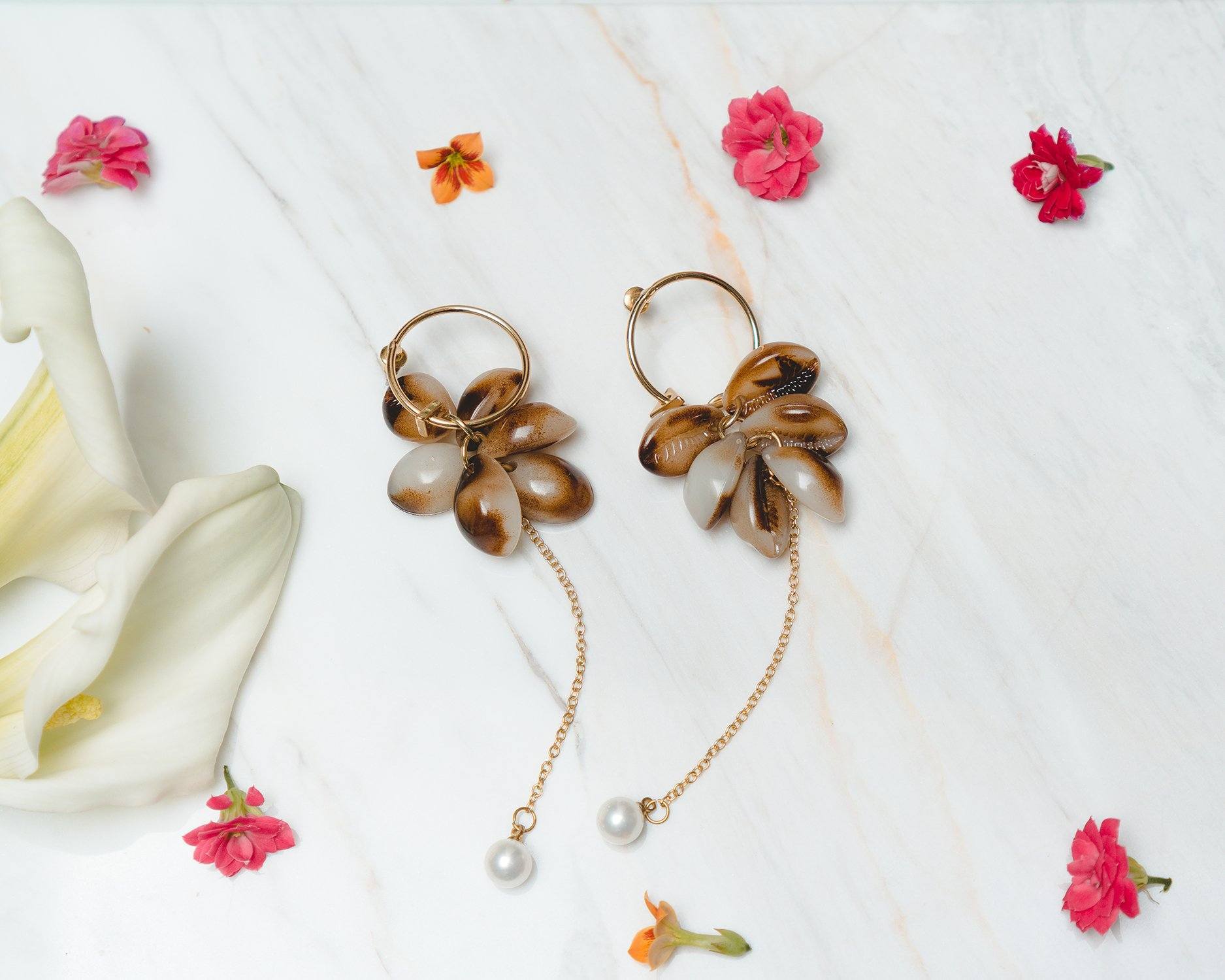 Elegant Look and Dangle Tortoiseshell Earrings featuring gold tone, pearlized accents, and shell charms.