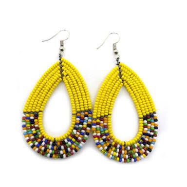 A pair of vibrant yellow Maasai beaded earrings, featuring an oval shape and intricate beadwork, perfect for any outfit.