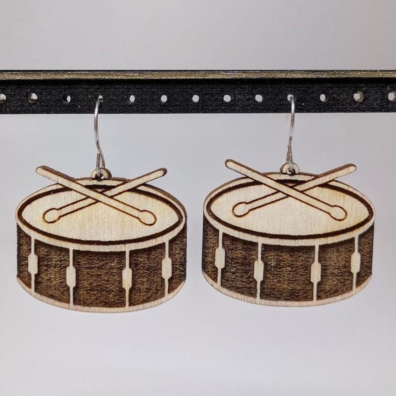 A pair of lightweight wooden earrings shaped like various musical instruments, including guitars and drums, with sterling silver ear wires.