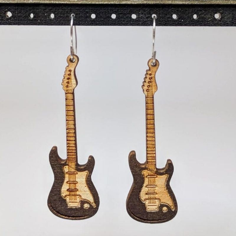 A pair of lightweight wooden earrings shaped like various musical instruments, including guitars and drums, with sterling silver ear wires.