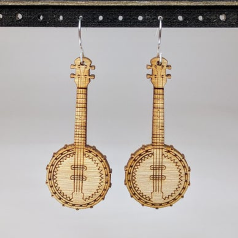 A pair of lightweight wooden earrings shaped like musical instruments, featuring intricate designs and sterling silver ear wires.