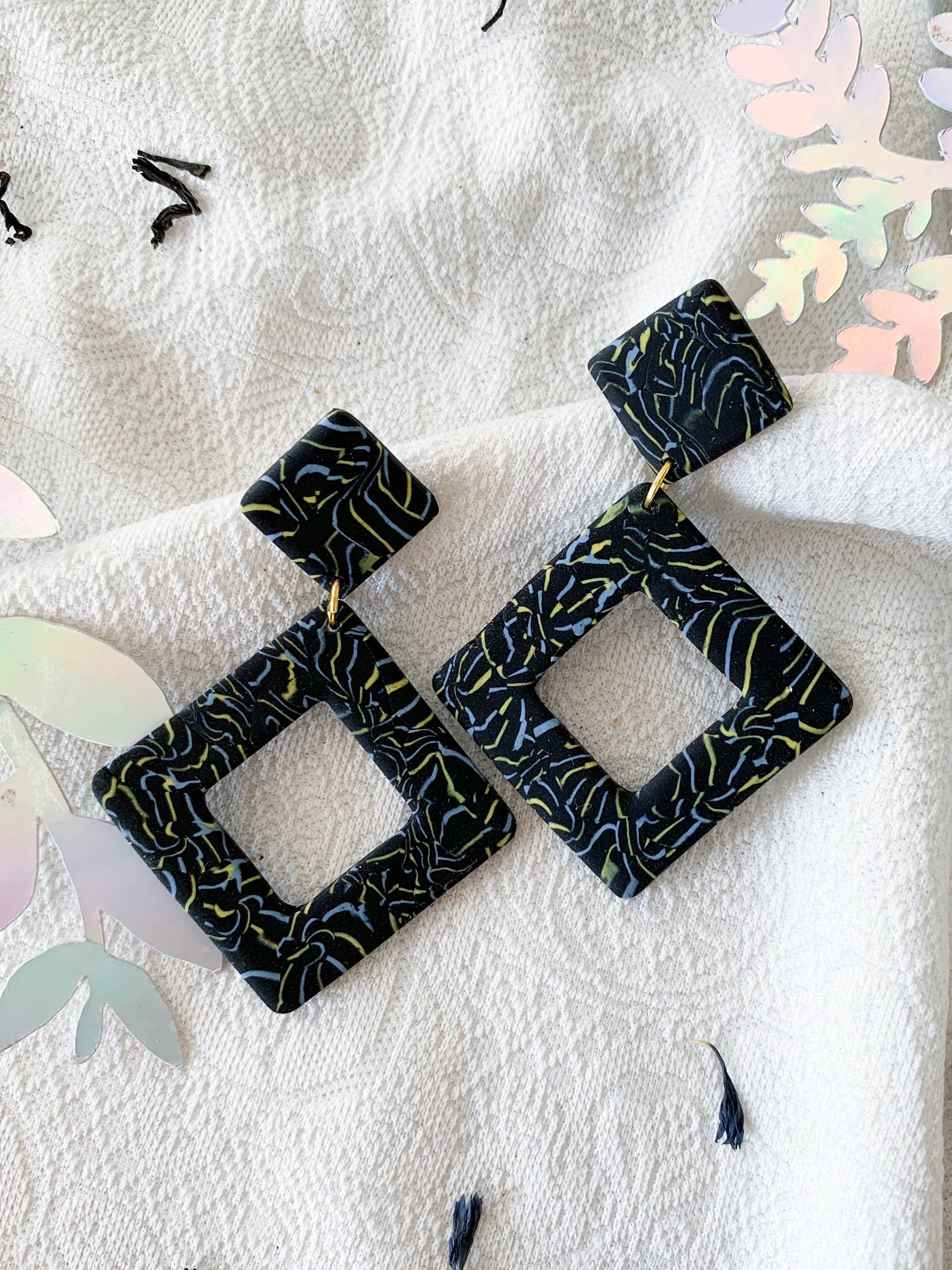 Nicole Earl Grey earrings featuring black, blue, and yellow marbling in a geometric rhombus shape, designed for elegance and comfort.