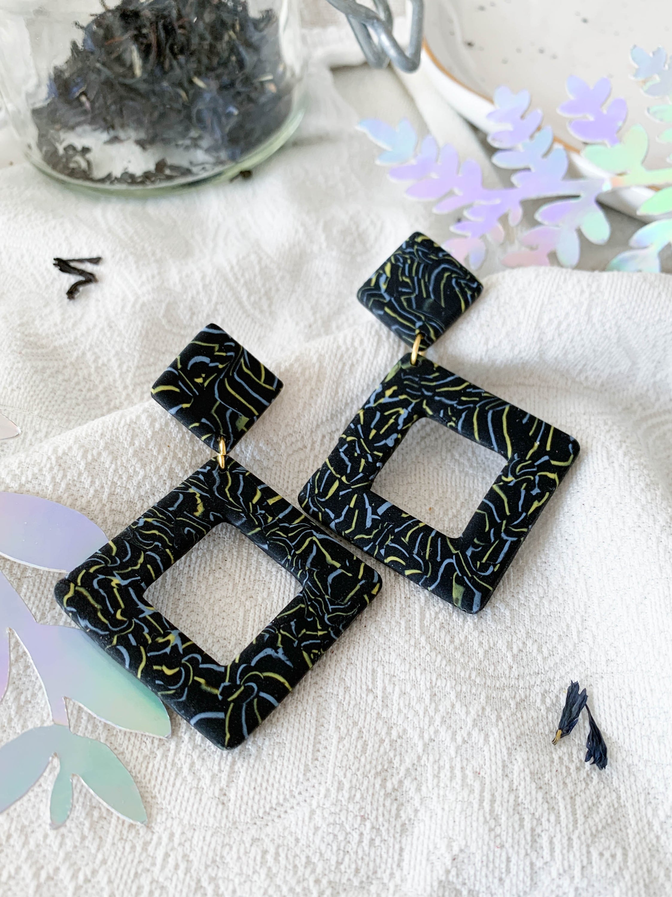 Nicole Earl Grey earrings featuring black, blue, and yellow marbling in a geometric rhombus shape, designed for elegance and comfort.