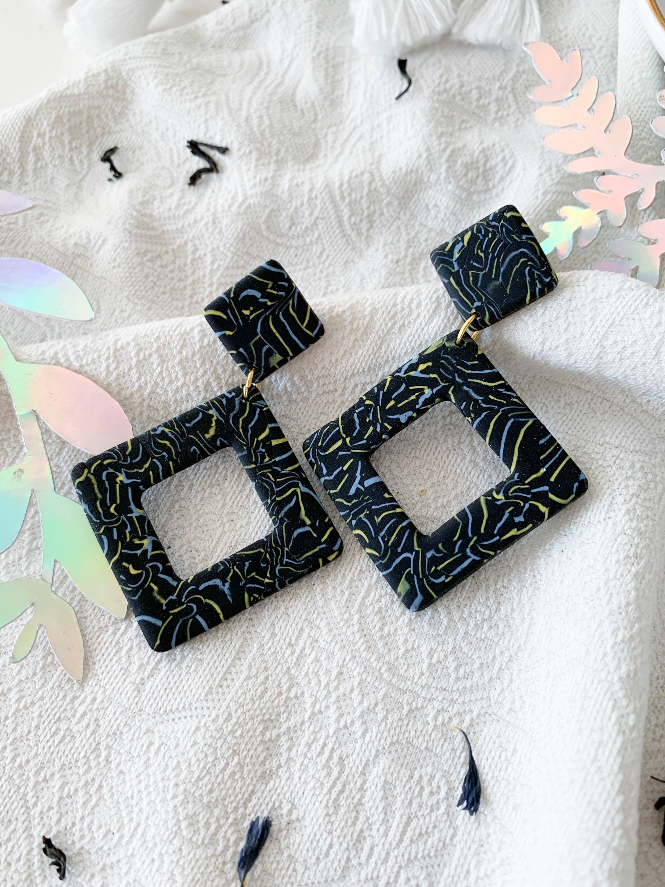 Nicole Earl Grey earrings featuring black, blue, and yellow marbling in a geometric rhombus shape, designed for elegance and comfort.