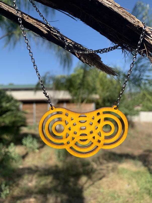 Overlapping Circles Necklace #6127 featuring laser-cut wood and stainless steel chain, showcasing a geometric design.