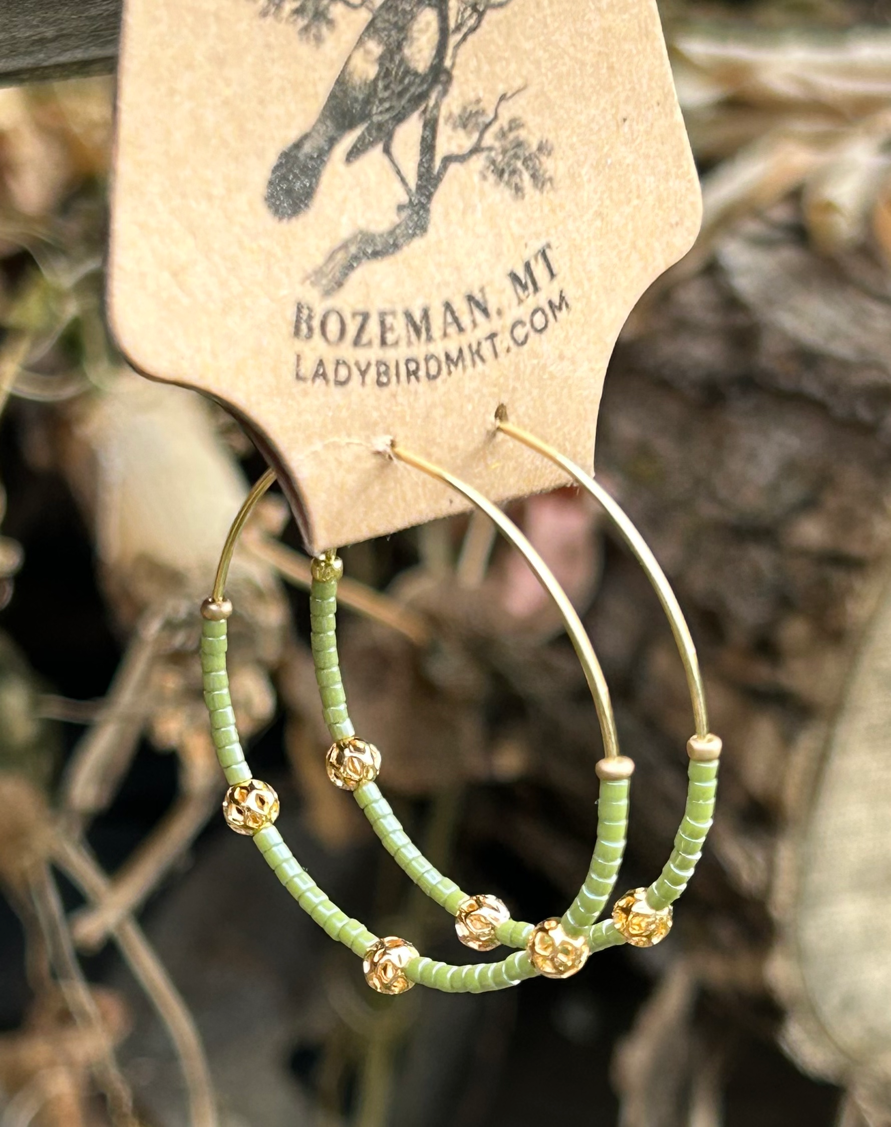 Pale green and gold beaded hoop earrings featuring Miyuki Delica seed beads and metallic gold lattice beads, elegantly designed for bohemian style.