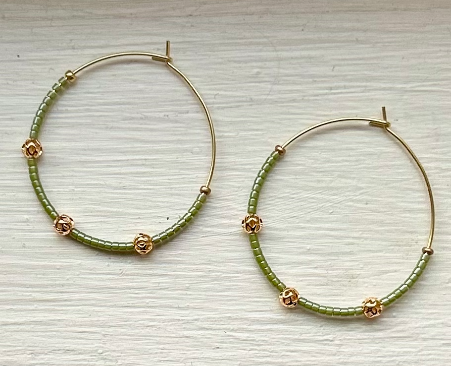 Pale green and gold beaded hoop earrings featuring Miyuki Delica seed beads and metallic gold lattice beads, elegantly designed for bohemian style.