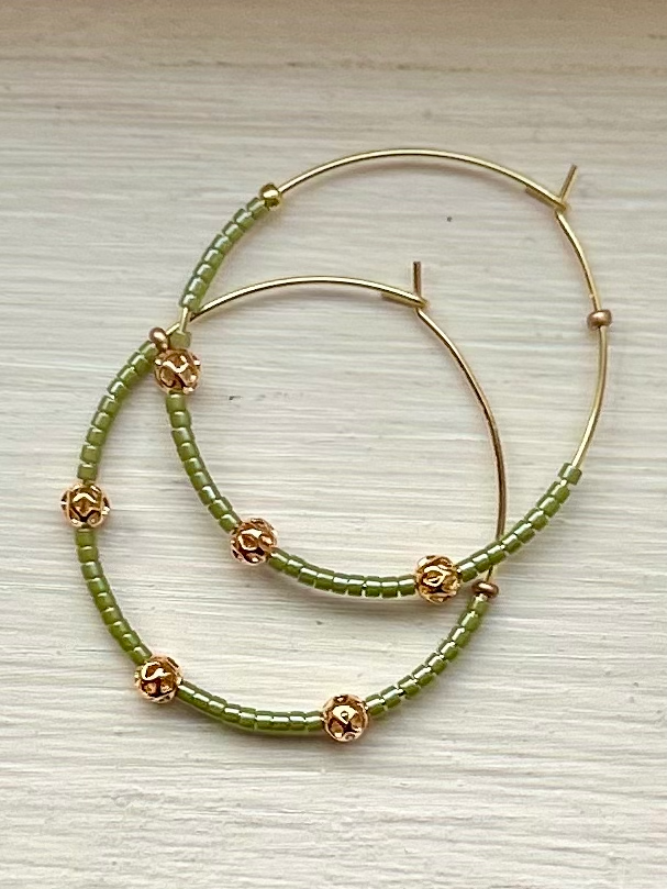 Pale green and gold beaded hoop earrings featuring Miyuki Delica seed beads and metallic gold lattice beads, elegantly designed for bohemian style.