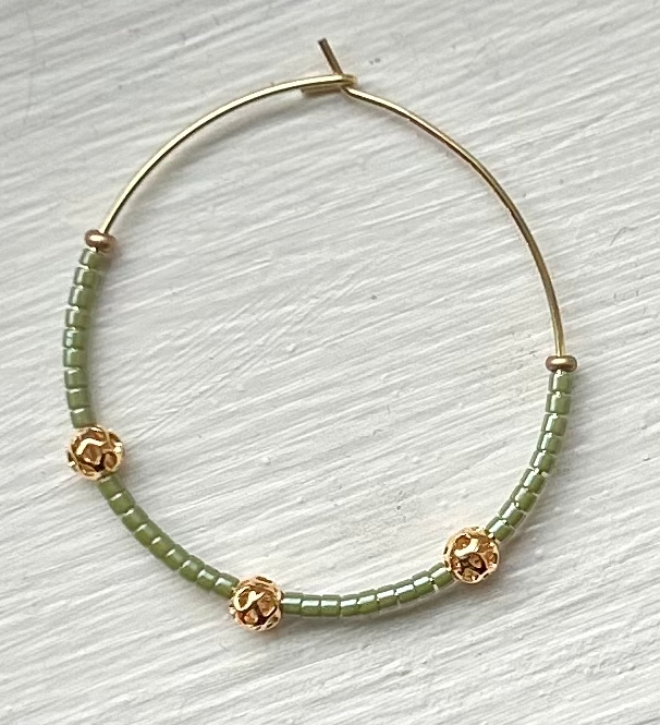 Pale green and gold beaded hoop earrings featuring Miyuki Delica seed beads and metallic gold lattice beads, elegantly designed for bohemian style.