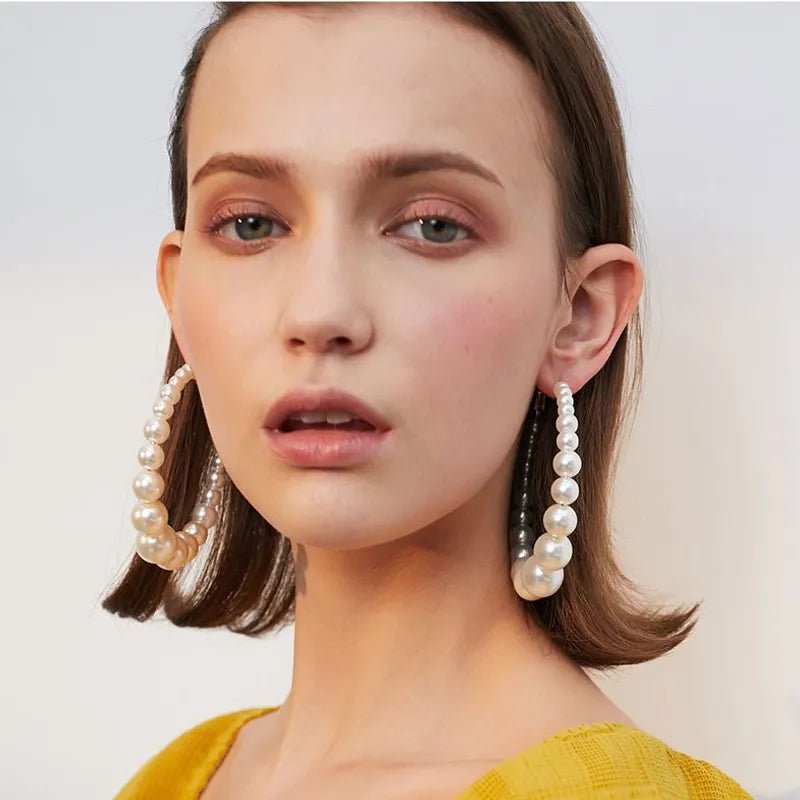 Trendy Pearl Girl Glam hoop earrings featuring pearl-like beads and gold accents, perfect for stylish accessorizing.