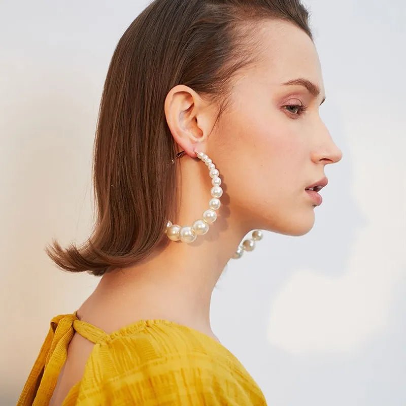 Trendy Pearl Girl Glam hoop earrings featuring pearl-like beads and gold accents, perfect for stylish accessorizing.