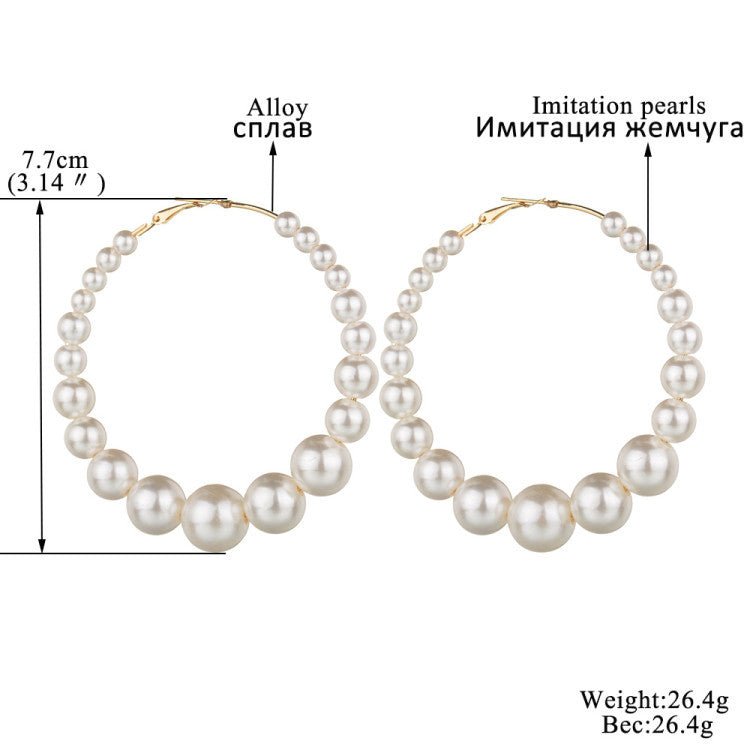 Trendy Pearl Girl Glam hoop earrings featuring pearl-like beads and gold accents, perfect for stylish accessorizing.