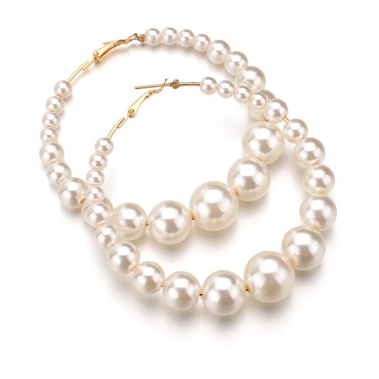 Trendy Pearl Girl Glam hoop earrings featuring pearl-like beads and gold accents, perfect for stylish accessorizing.