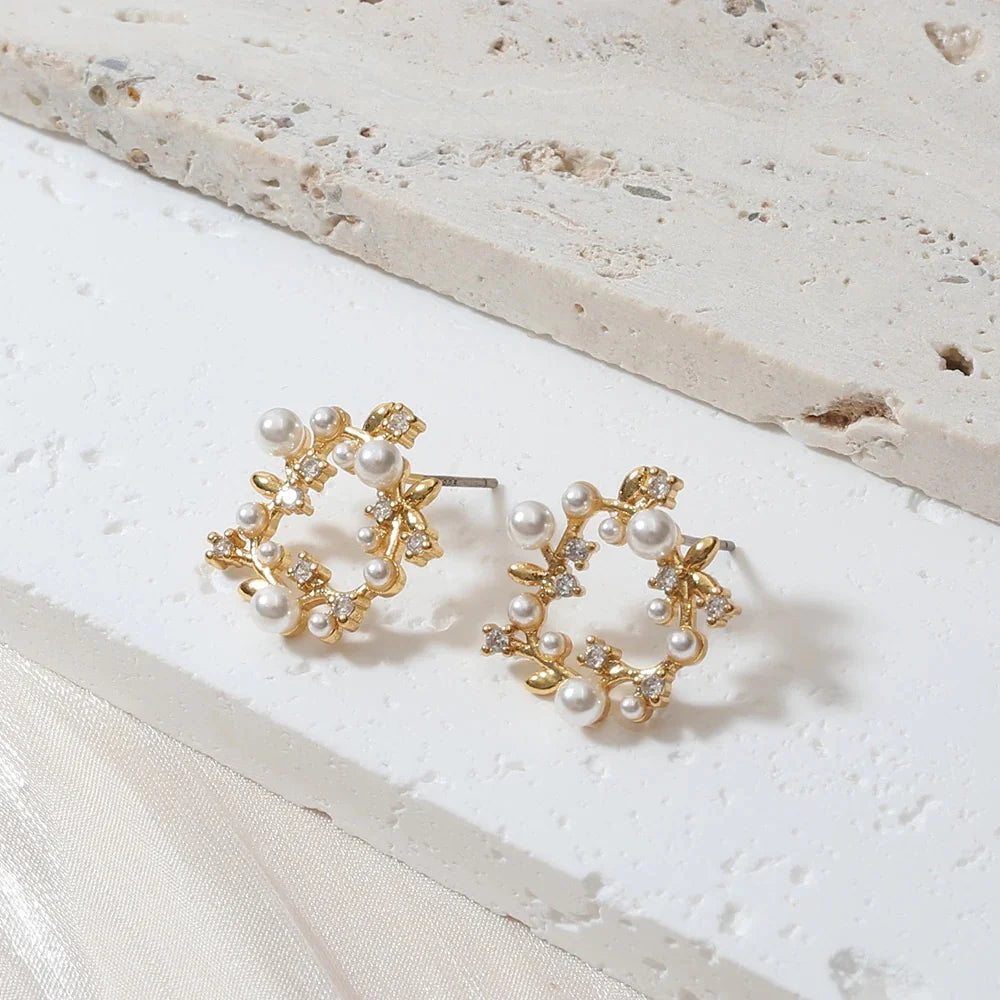 Elegant gold-plated pearl wreath earrings adorned with small diamonds, showcasing a luxurious and sophisticated design.