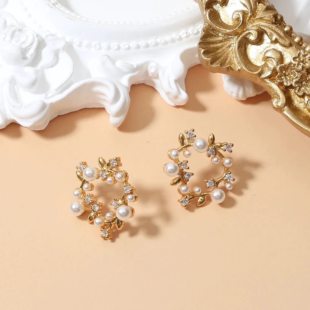 Elegant gold-plated pearl wreath earrings adorned with small diamonds, showcasing a luxurious and sophisticated design.