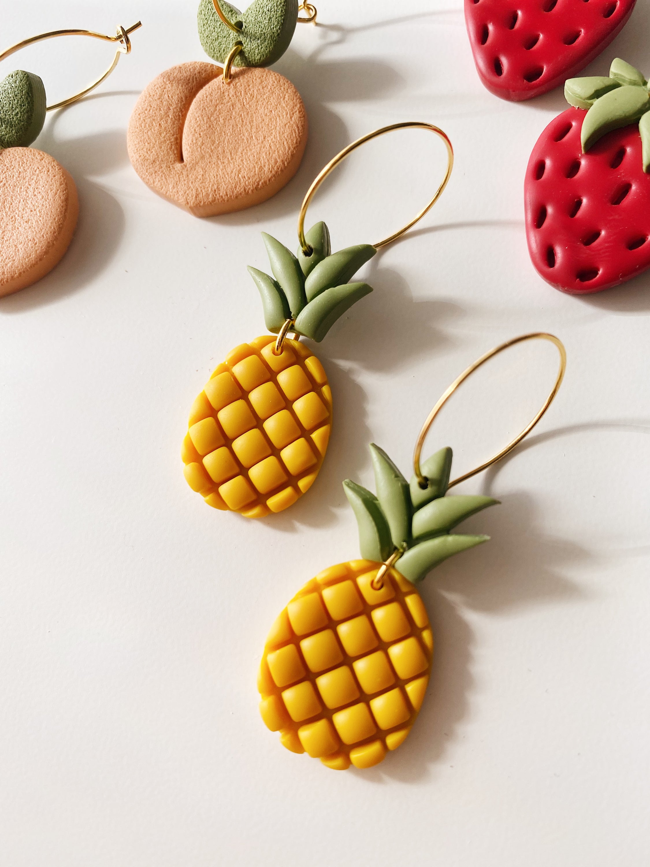 Handcrafted Pineapple Hoops earrings with hypoallergenic posts, showcasing unique design and vibrant colors.