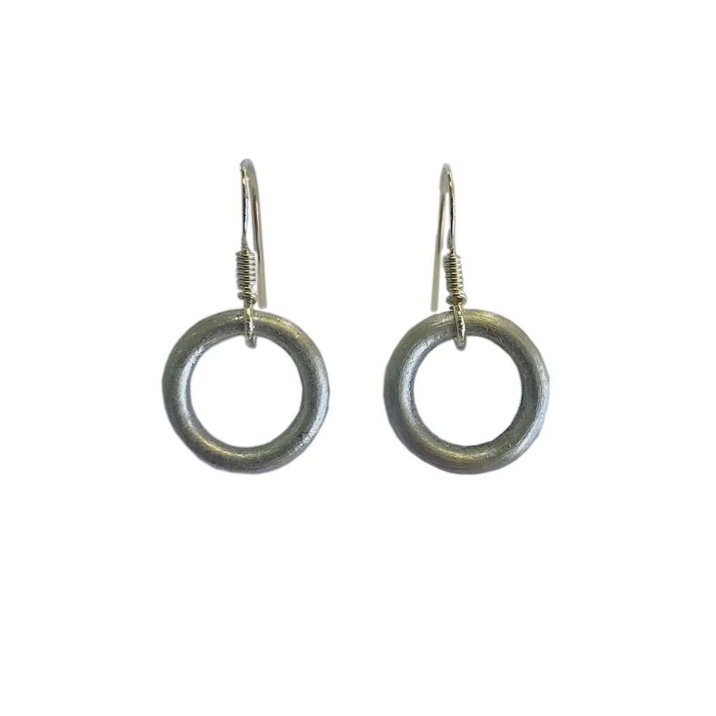 A pair of Recycled Bomb Circle Earrings made from aluminum bomb parts, showcasing a unique circular design, handcrafted in Laos.