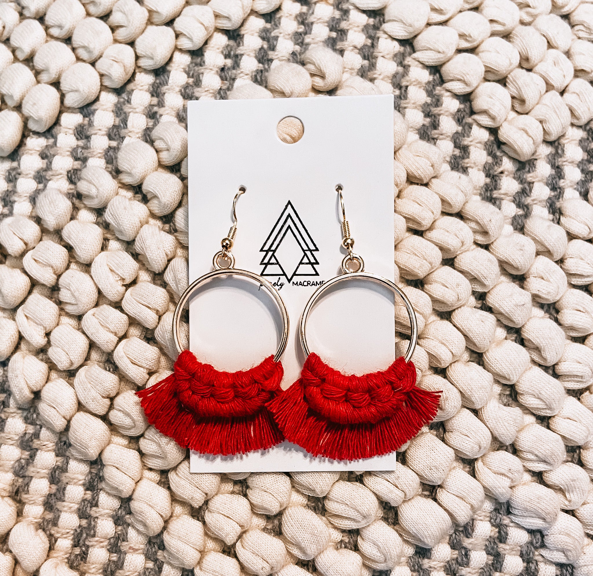 A pair of lightweight Red Gold Hoops made from macrame cotton, showcasing a vibrant red color with gold accents.