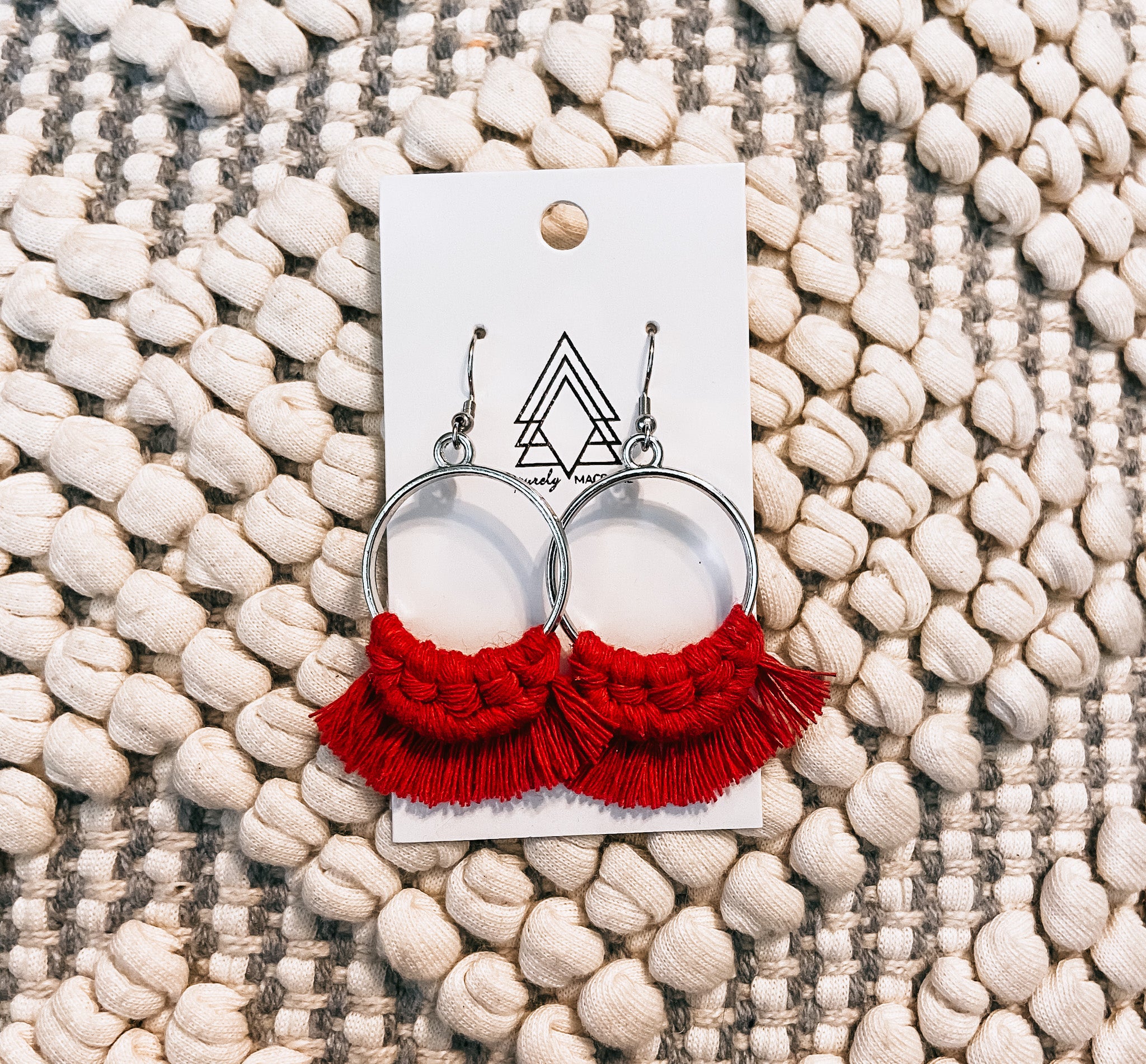 A pair of vibrant red round earrings made from macrame cotton, showcasing their lightweight and stylish design.