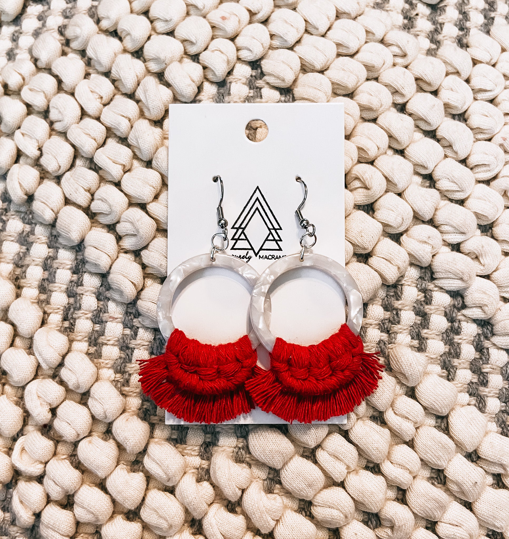 A pair of lightweight red tortoise earrings made from macrame cotton, showcasing a unique design.