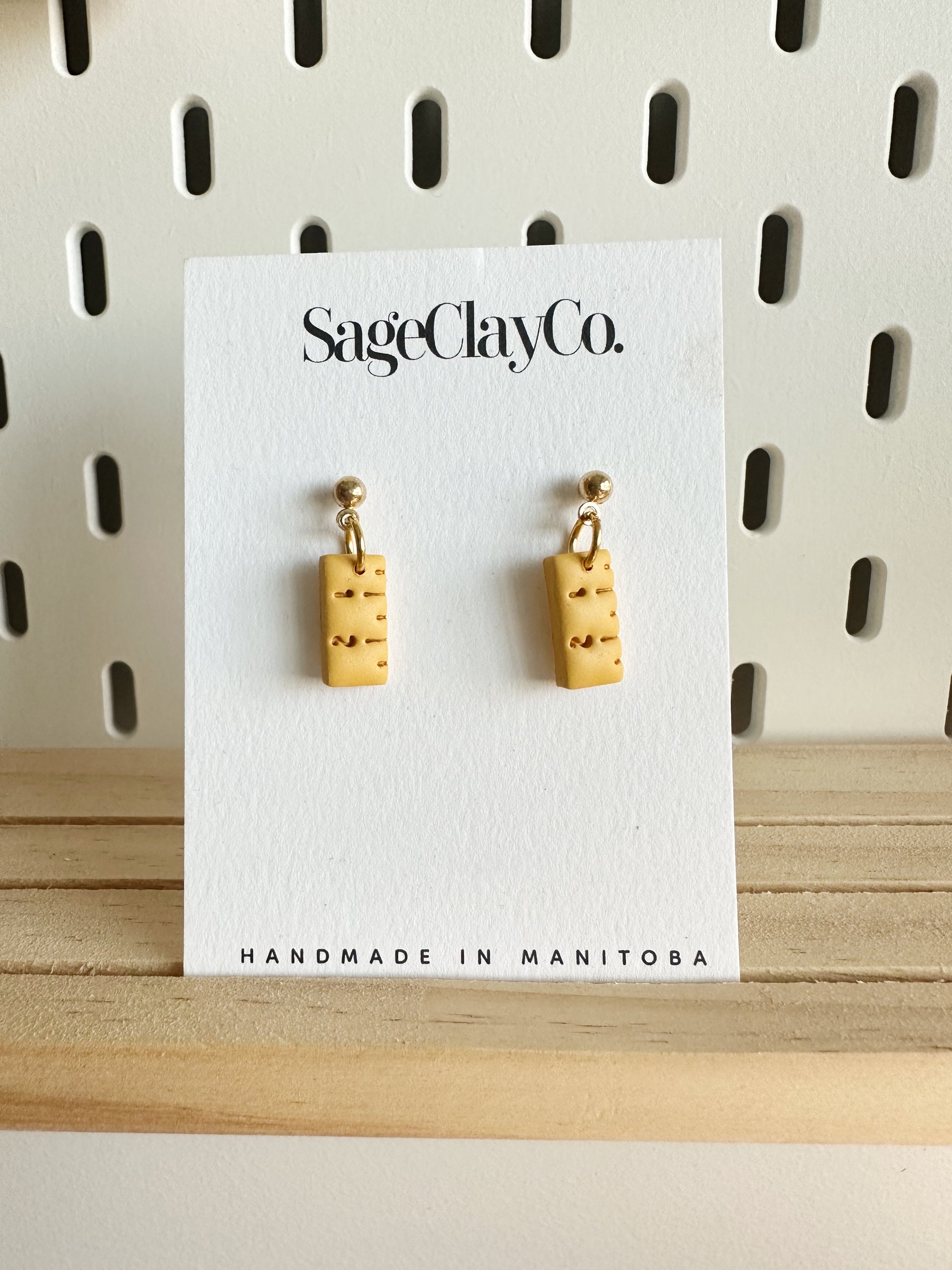 Handmade polymer clay earrings shaped like rulers, featuring a minimalist design perfect for teachers.