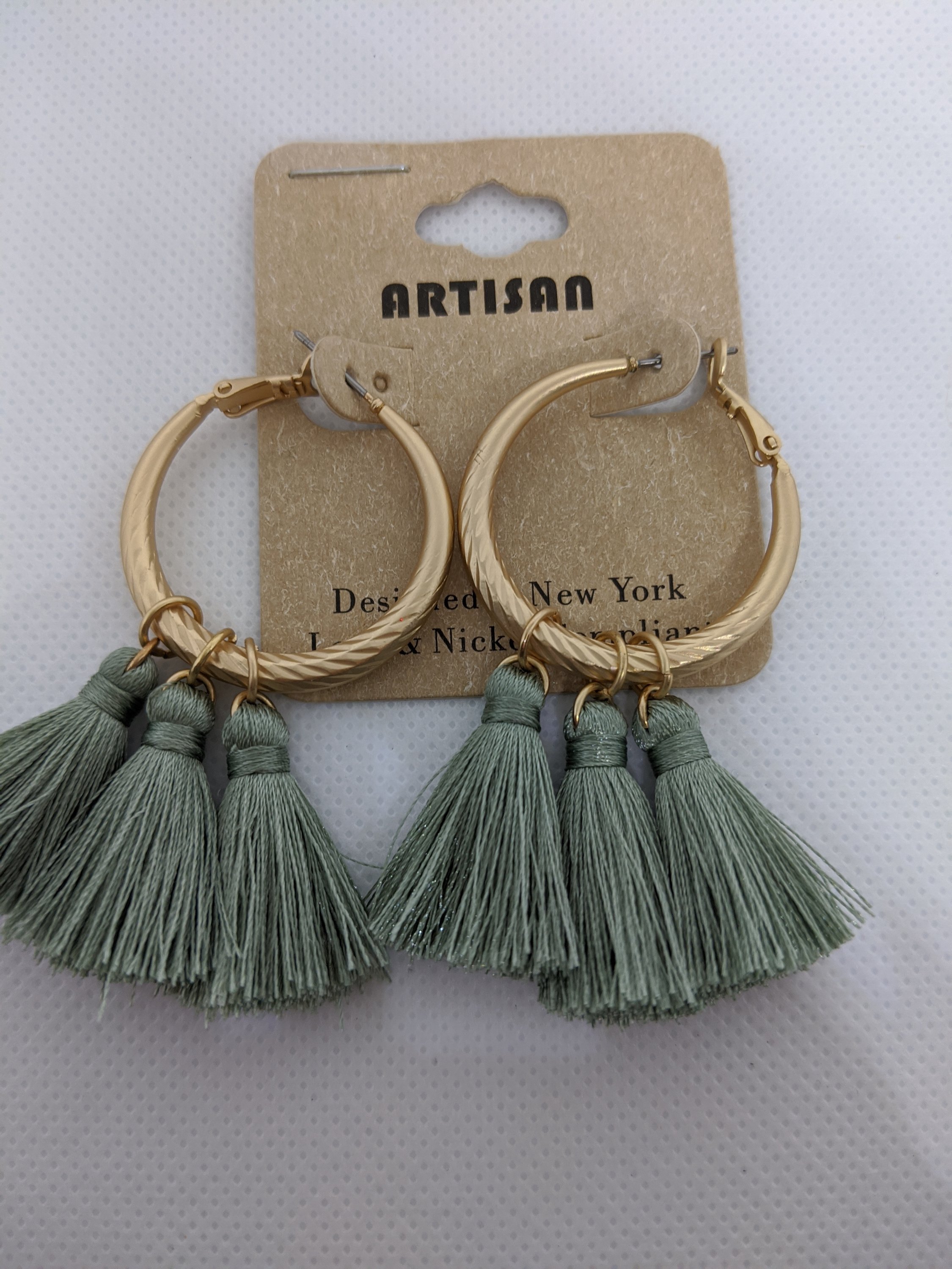 A pair of stylish sage green tassel hoop earrings, lightweight and trendy, perfect for spring fashion.