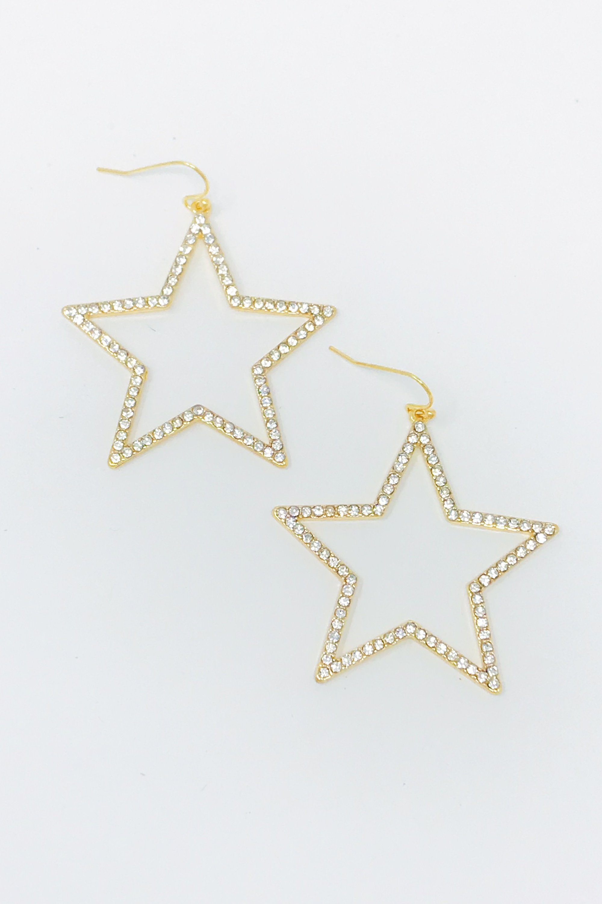 Gold tone fish hook star earrings adorned with clear cubic zirconia stones, measuring 1.5 inches.