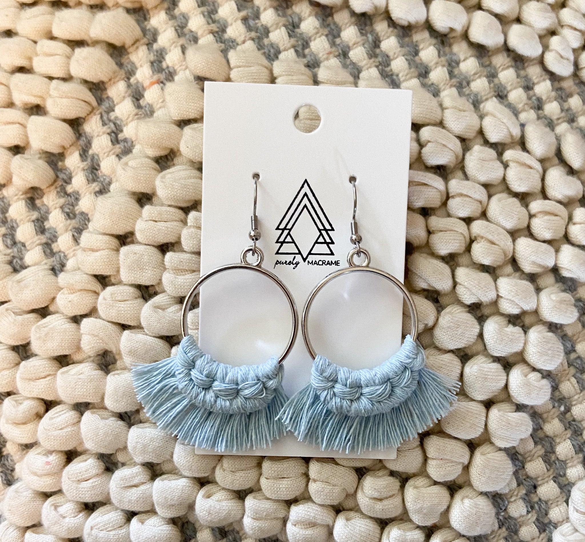 A pair of stylish sky blue round earrings made from 100% macrame cotton, lightweight and hypoallergenic, perfect for any occasion.