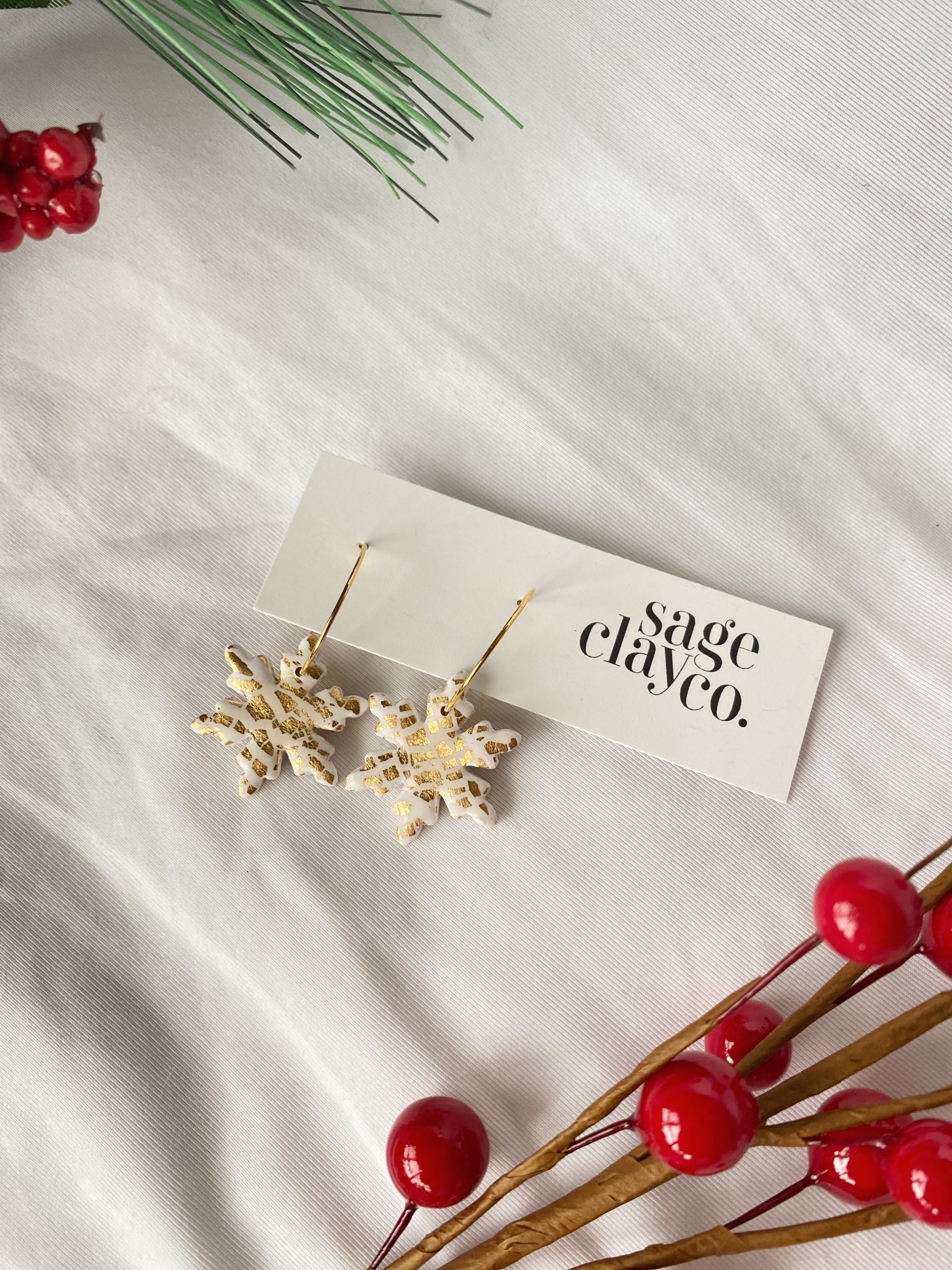 A pair of handcrafted Snow Flake Hoops earrings, showcasing a unique design with a delicate snowflake pattern, perfect for winter fashion.