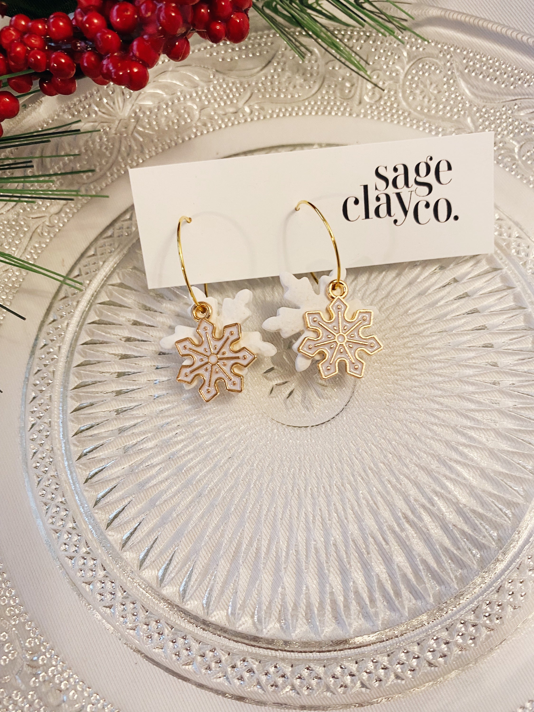 A pair of handcrafted Snow Flake Hoops earrings, showcasing a unique design with a delicate snowflake pattern, perfect for winter fashion.